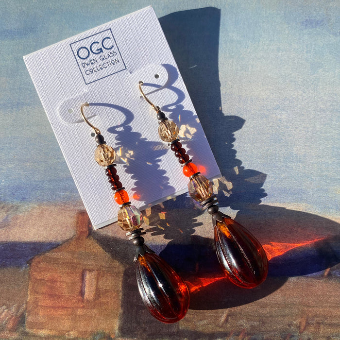 Dark topaz seedpod glass drop earrings with Austrian crystal accents by Owen Glass Collection, featuring elegant, translucent gemstone design.