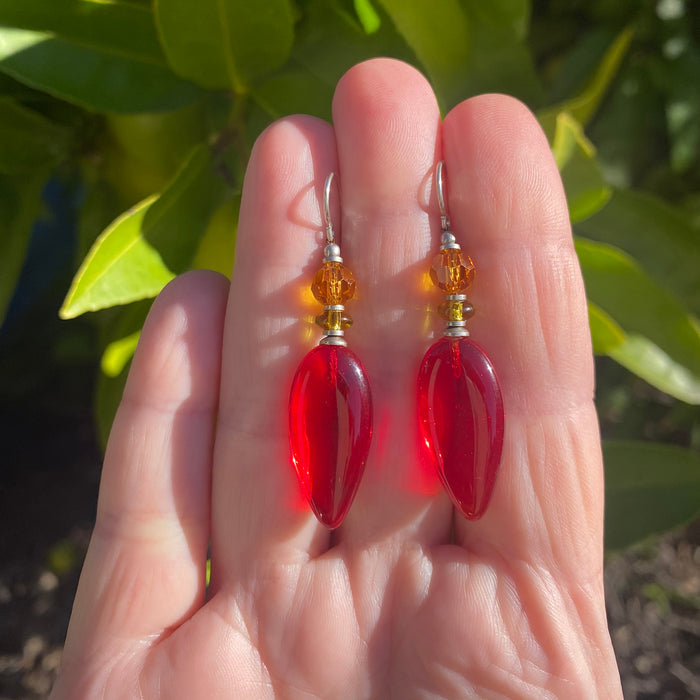 Red glass dangle earrings from Owen Glass Collection, featuring vibrant, reflective glass teardrop design with silver hooks.