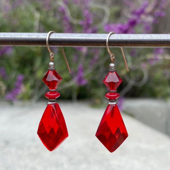 Red glass earrings from the Owen Glass Collection featuring the "564" design, with smooth, vibrant glass drops hanging elegantly.