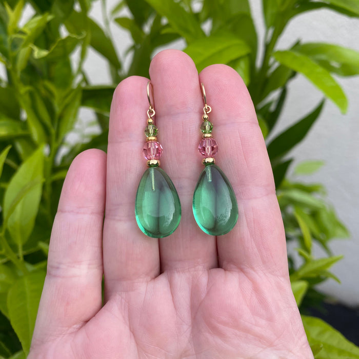 Peridot and pink gold dangle earrings from Owen Glass Collection, showcasing elegant jewelry with vibrant green stones.