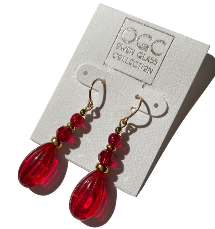 Red glass and gold dangle earrings from Owen Glass Collection featuring intricate glass and metal details.