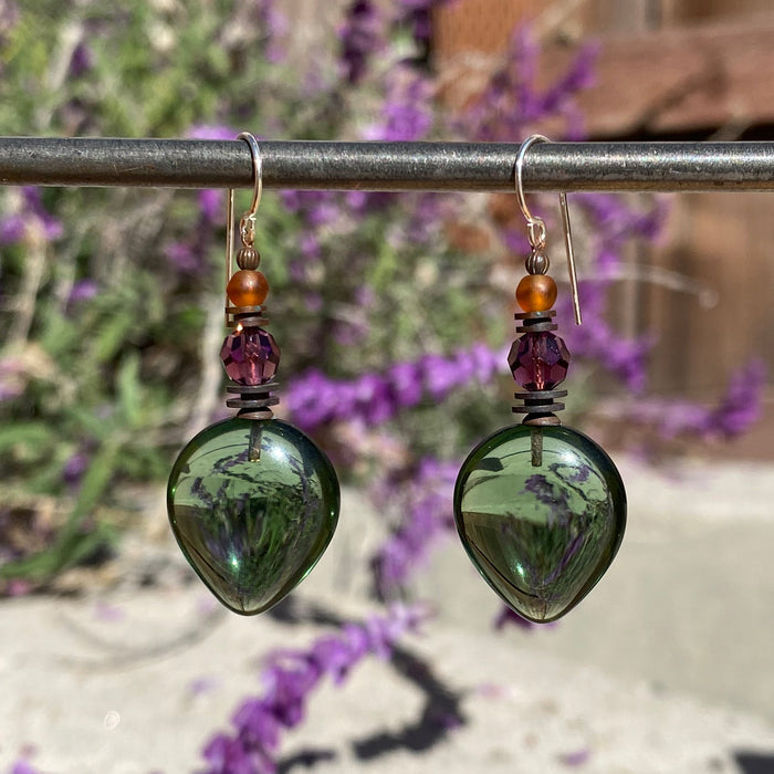 Owen Glass Collection almond-shaped green glass dangle earrings with amethyst crystal accents and tourmaline green details.