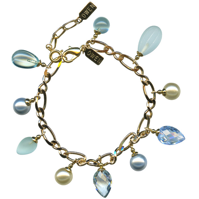 Owen Glass Collection Aqua Crystal and Gold Charm Bracelet featuring aqua blue crystals and gold accents on a delicate bracelet.