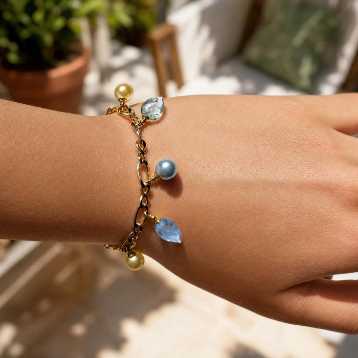 Owen Glass Collection Aqua Crystal and Gold Charm Bracelet featuring aqua crystal beads and gold charm accents.
