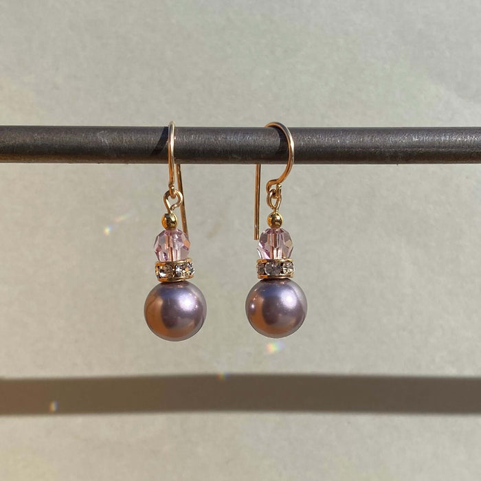 Owen Glass Collection Bells 57 light amethyst crystal pearl earrings with gold trim, featuring elegant dangling design.