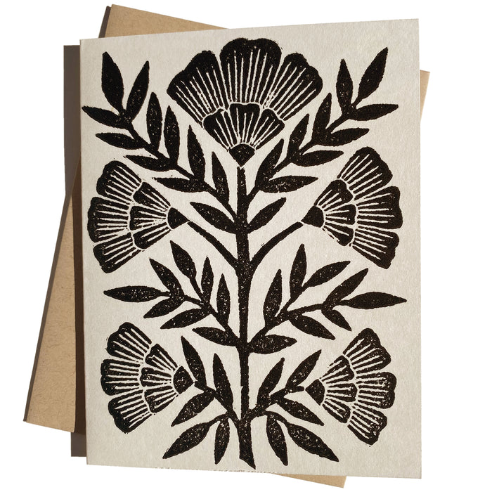Black block printed flower greeting card from Owen Glass Collection with intricate floral design.