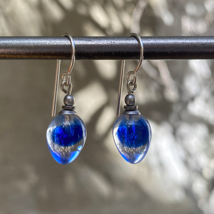 Owen Glass Collection COLORS 21 earrings featuring vibrant, colorful glass bead designs on silver hooks.