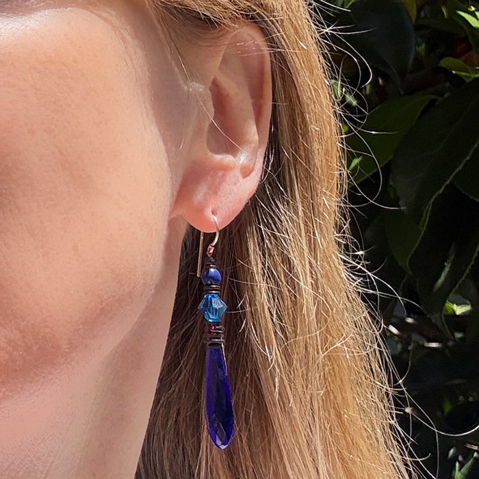 Cobalt blue glass chandelier earrings from Owen Glass Collection with intricate design and dangling blue glass beads.