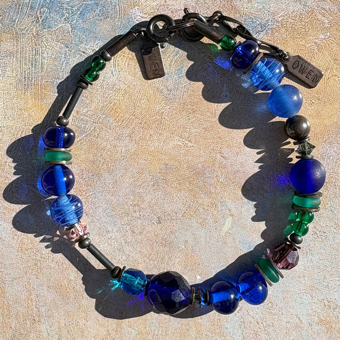 Cobalt and emerald crystal beaded bracelet from Owen Glass Collection showcasing vibrant, polished gemstone beads and elegant design.
