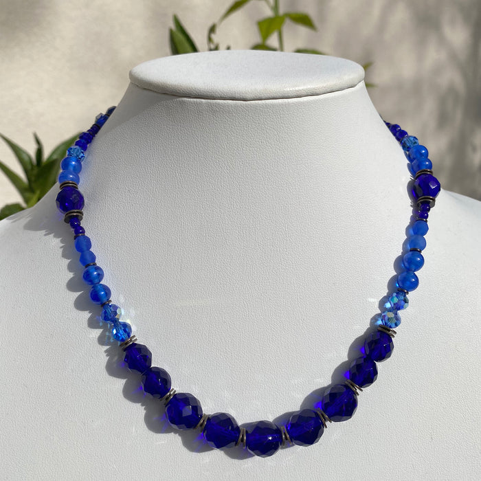 Beaded blue necklace with bronze accents from Owen Glass Collection, 18 inches long, featuring cobalt tones and intricate beadwork.