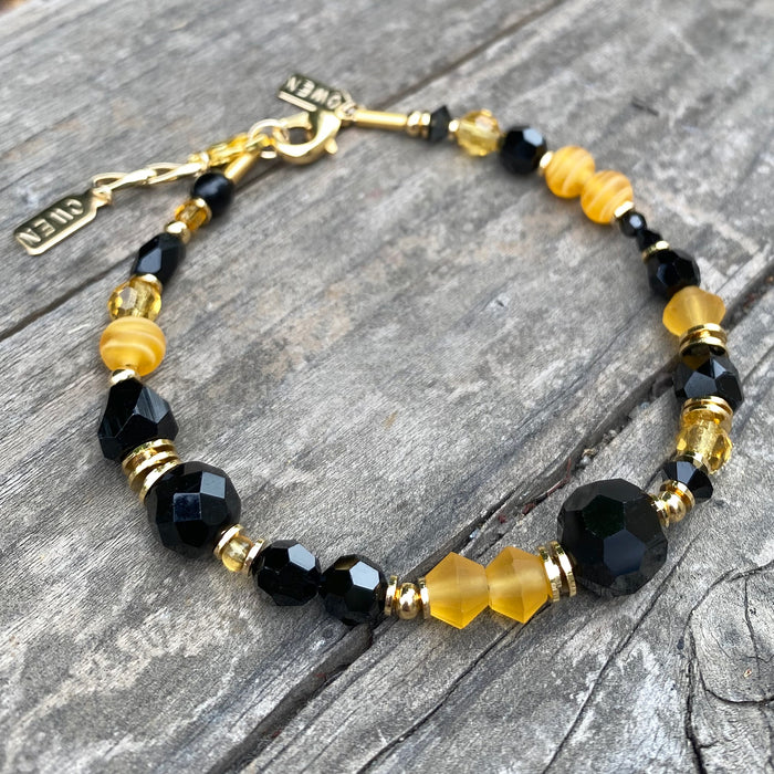 Elegant Czech glass and Austrian crystal bracelet from Owen Glass Collection featuring a goldfinch design on a delicate gold-tone chain.