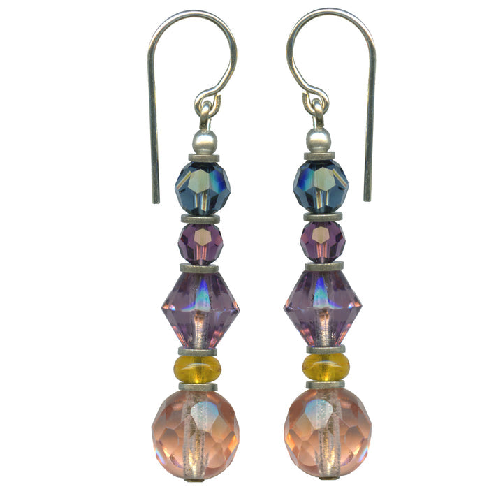 Owen Glass Collection FAUNA 4 earrings featuring intricate animal-inspired metal design on a neutral background.
