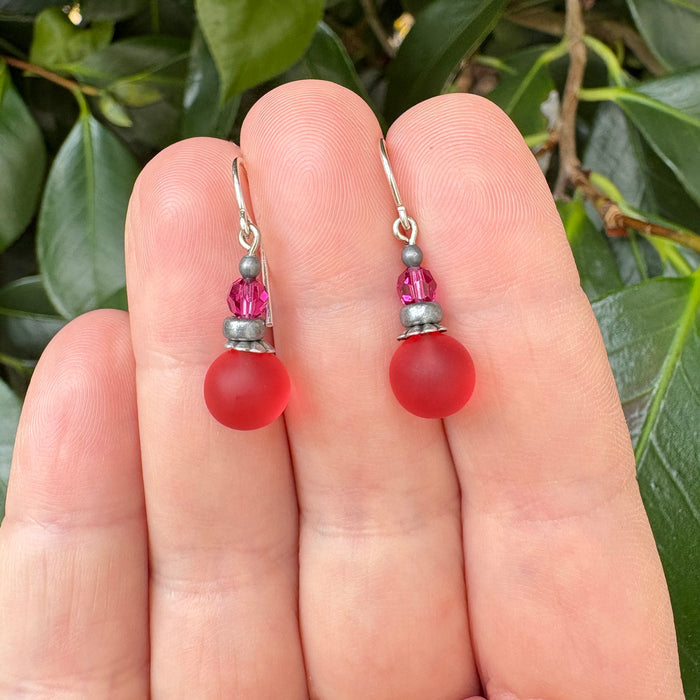 Frosted rose pink glass and fuchsia crystal drop earrings from Owen Glass Collection, showcasing elegant hanging jewelry design.
