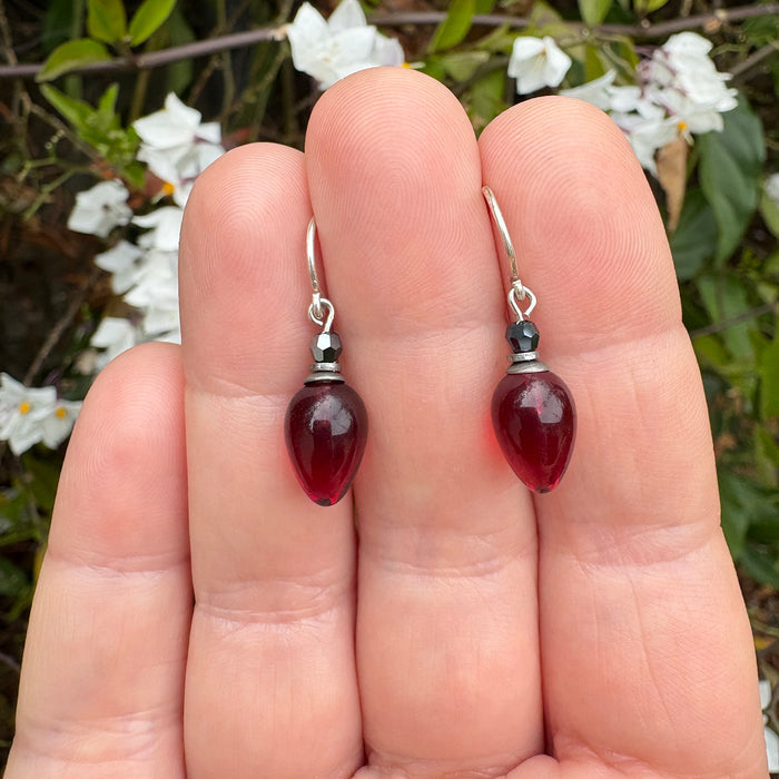 Garnet glass and jet crystal dangle earrings from Owen Glass Collection featuring plum-shaped design and sparkling accents.