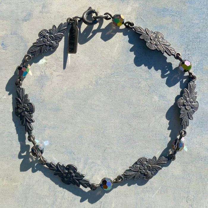 Iridescent Austrian crystal bracelet with intricate filigree design from Owen Glass Collection, showcasing shimmering crystal details.