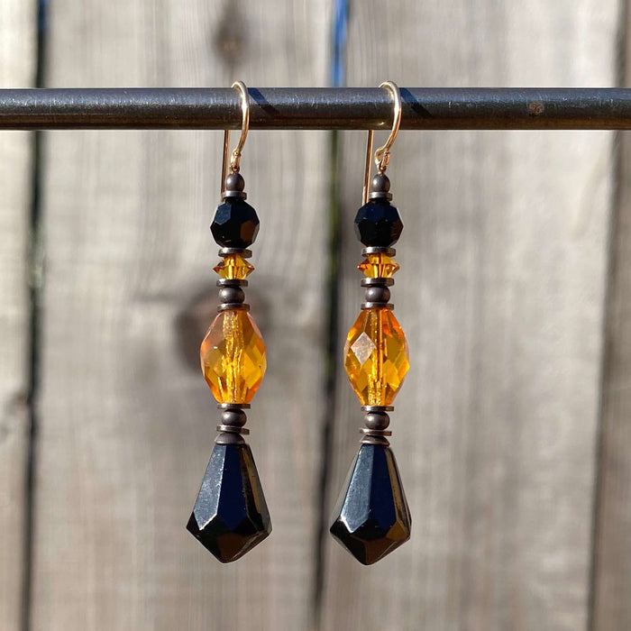 Owen Glass Collection 66-inch jet and topaz glass and crystal dangle earrings with intricate design and sparkling details.