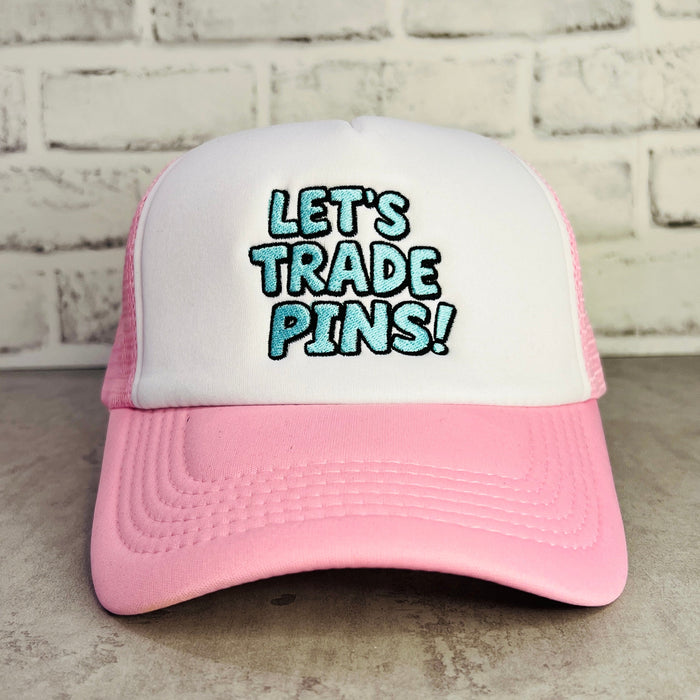 Pink and white trucker hat with 'LET'S TRADE PINS!' text