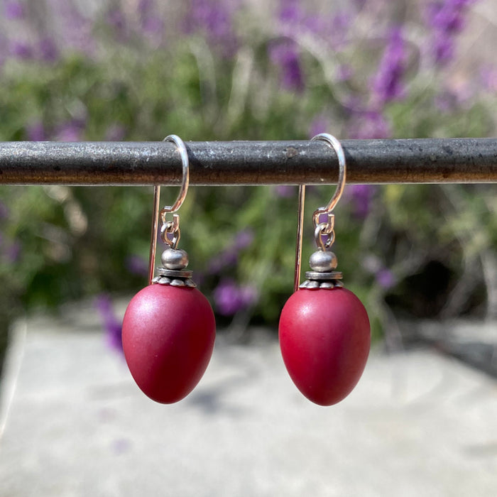Opaque red glass drop earrings with sterling silver accents from Owen Glass Collection’s Berries 60 series.