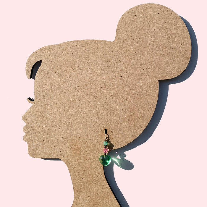 Peridot heart dangle earrings from Owen Glass Collection featuring vibrant green gemstones and elegant silver hooks.