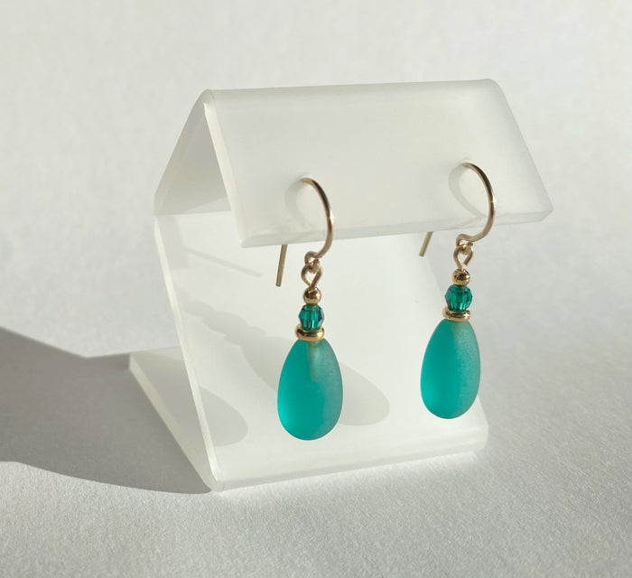 Frosted teal glass and gold earrings from Owen Glass Collection with raindrop-shaped design.