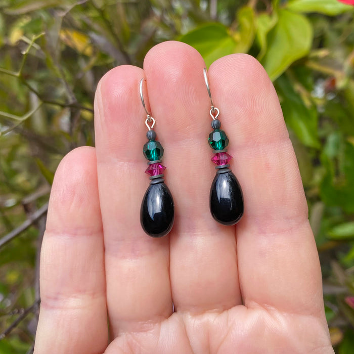 Owen Glass Collection Raindrops 98 jet glass drop earrings with emerald and fuchsia crystals, hanging with intricate design.