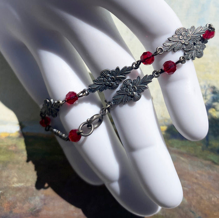 Red Austrian crystal bracelet with intricate filigree design from Owen Glass Collection, titled "Grace 12".