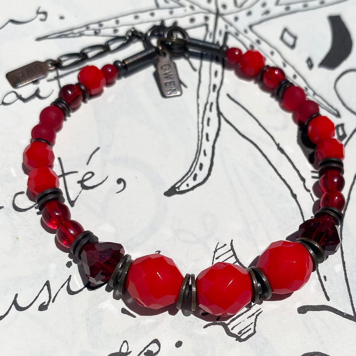 Beaded bracelet with red Czech glass, crystal beads, and bronze accents from Owen Glass Collection.