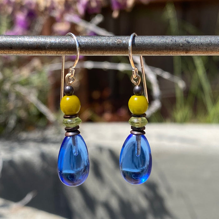 Sapphire German and Czech glass dangle earrings with raindrop design from Owen Glass Collection, featuring shimmering blue glass.