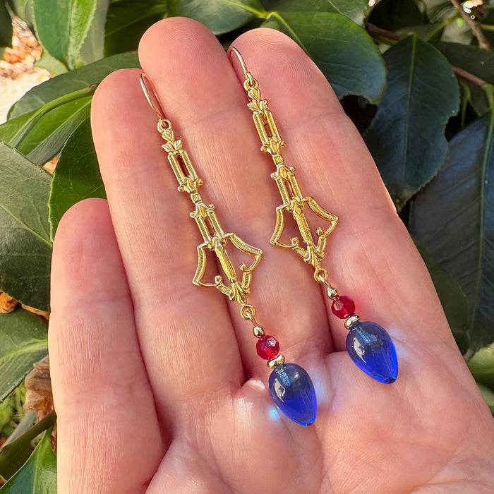 Owen Glass Collection Plums 72 earrings featuring sapphire glass, red crystals, and gold filigree design on elegant dangle earrings