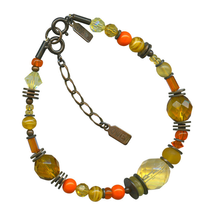 Owen Glass Collection Solaris bronze bracelet featuring intricate design and adjustable cord, stylish jewelry accessory.