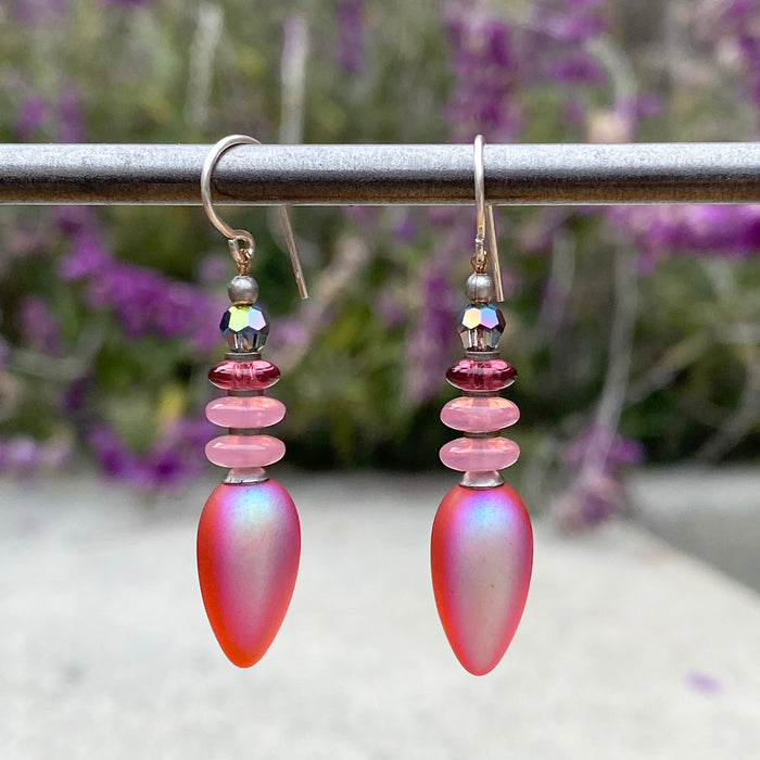 Frosted pink iridescent glass earrings from Owen Glass Collection, showcasing smooth, elegant, dangling earring design.
