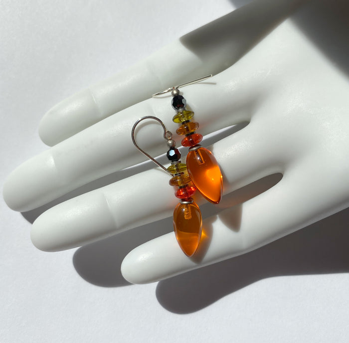 Orange glass dangle earrings from Owen Glass Collection featuring sleek, modern design with vibrant glass teardrops.