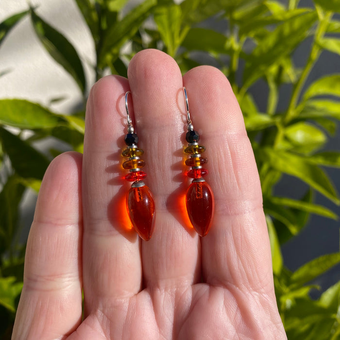 Owen Glass Collection Tango 8 orange glass dangle earrings with sleek, modern design hanging against a neutral background.