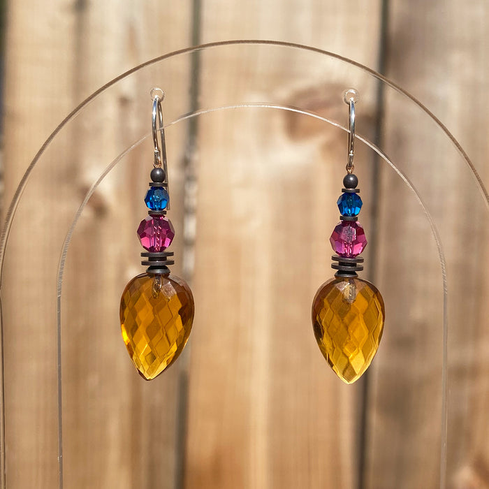 Owen Glass Collection Topaz glass dangle earrings featuring faceted teardrop-shaped gemstones hanging from silver hooks.