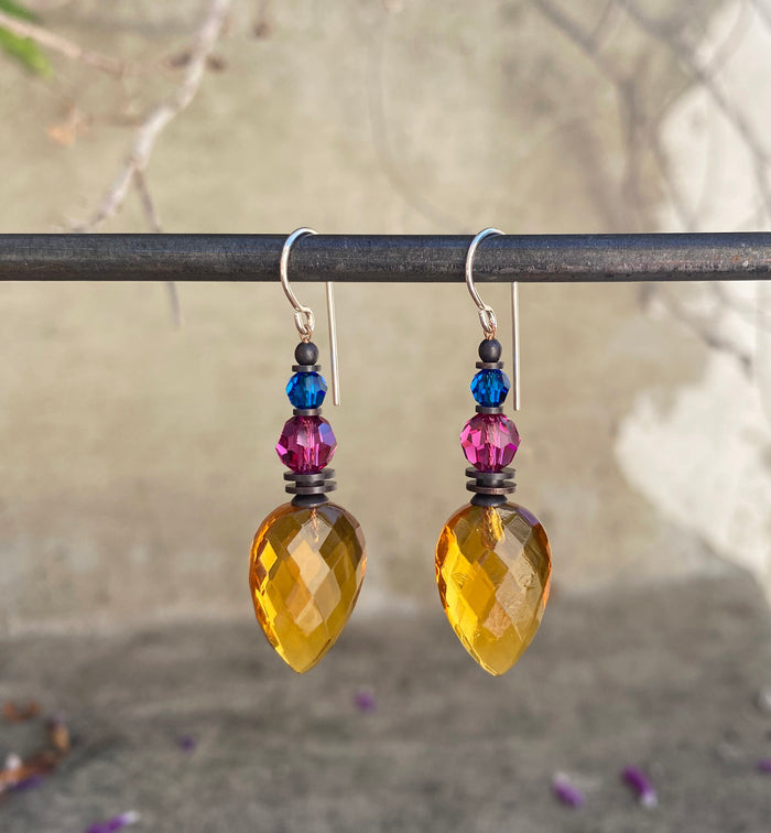 Owen Glass Collection Topaz glass dangle earrings featuring faceted teardrop-shaped gemstones on silver hooks.