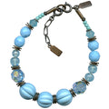 Turquoise tones bracelet with bronze accents from Owen Glass Collection, featuring beaded design and intricate metalwork.