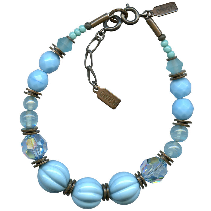 Turquoise tones bracelet with bronze accents from Owen Glass Collection, featuring beaded design and intricate metalwork.