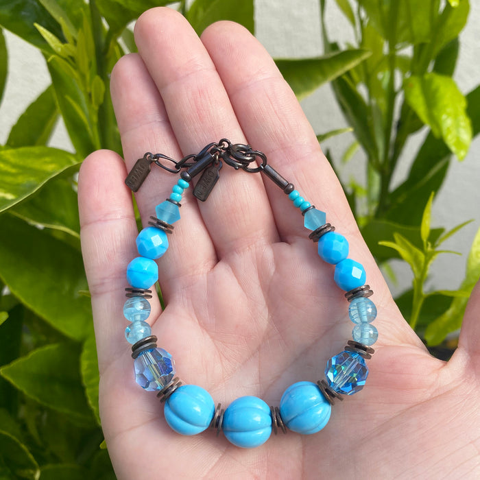 Turquoise tones bracelet with bronze accents from Owen Glass Collection, featuring beaded design and elegant craftsmanship.