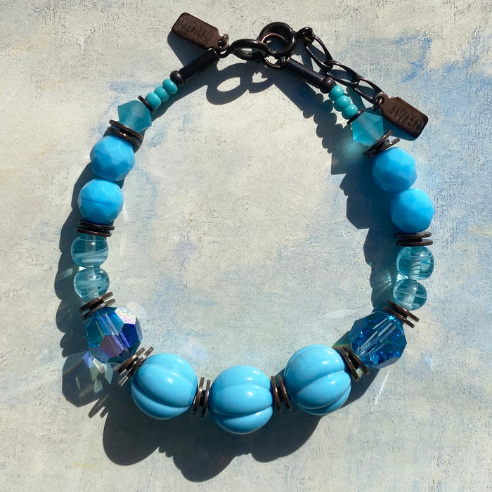 Turquoise tones bracelet with bronze accents from Owen Glass Collection, showcasing intricate beadwork and elegant design.